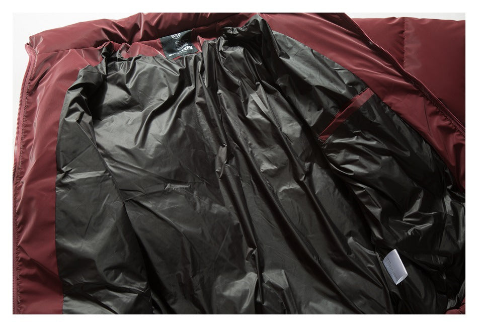 Burgundy jacket laid open to show its black lining, zipper, and interior label.