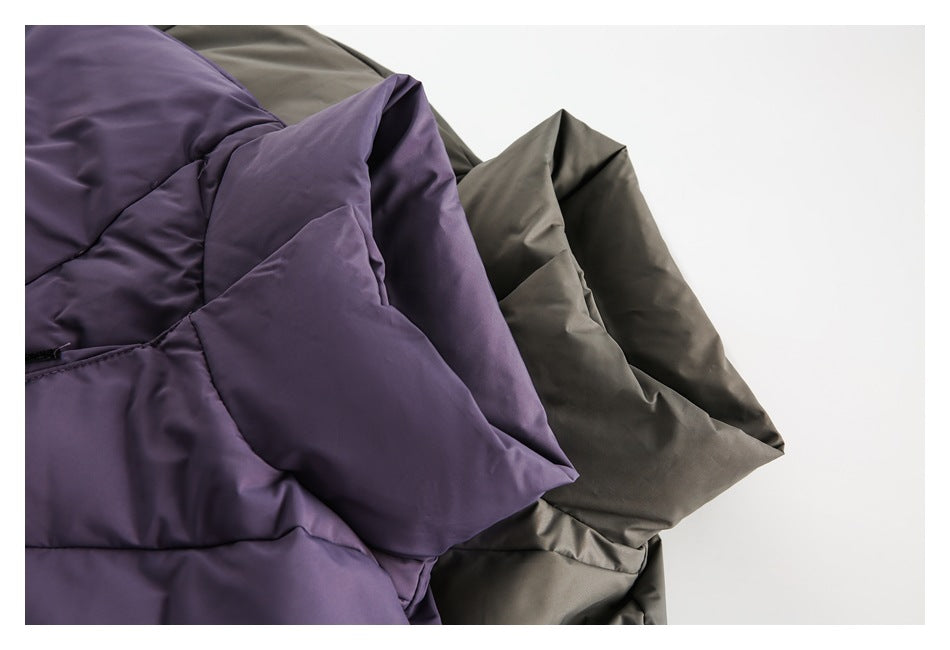 Close-up of overlapping purple and charcoal padded jacket panels with stitched quilting.