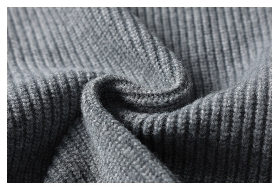 Close-up showing the texture and folds of gray ribbed knit fabric.
