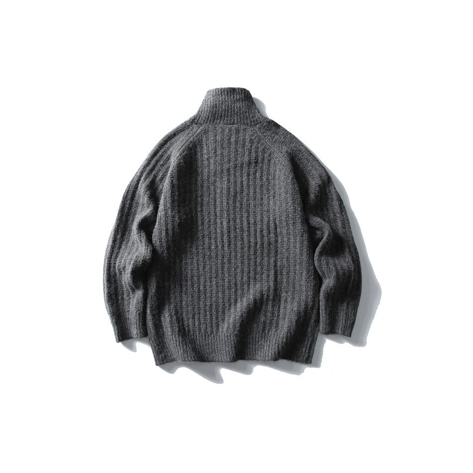 Back view of a charcoal gray rib-knit sweater with a high collar and long sleeves.