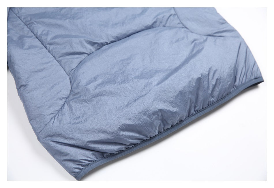 Close-up of a blue-gray garment panel with curved stitching and a bound edge.