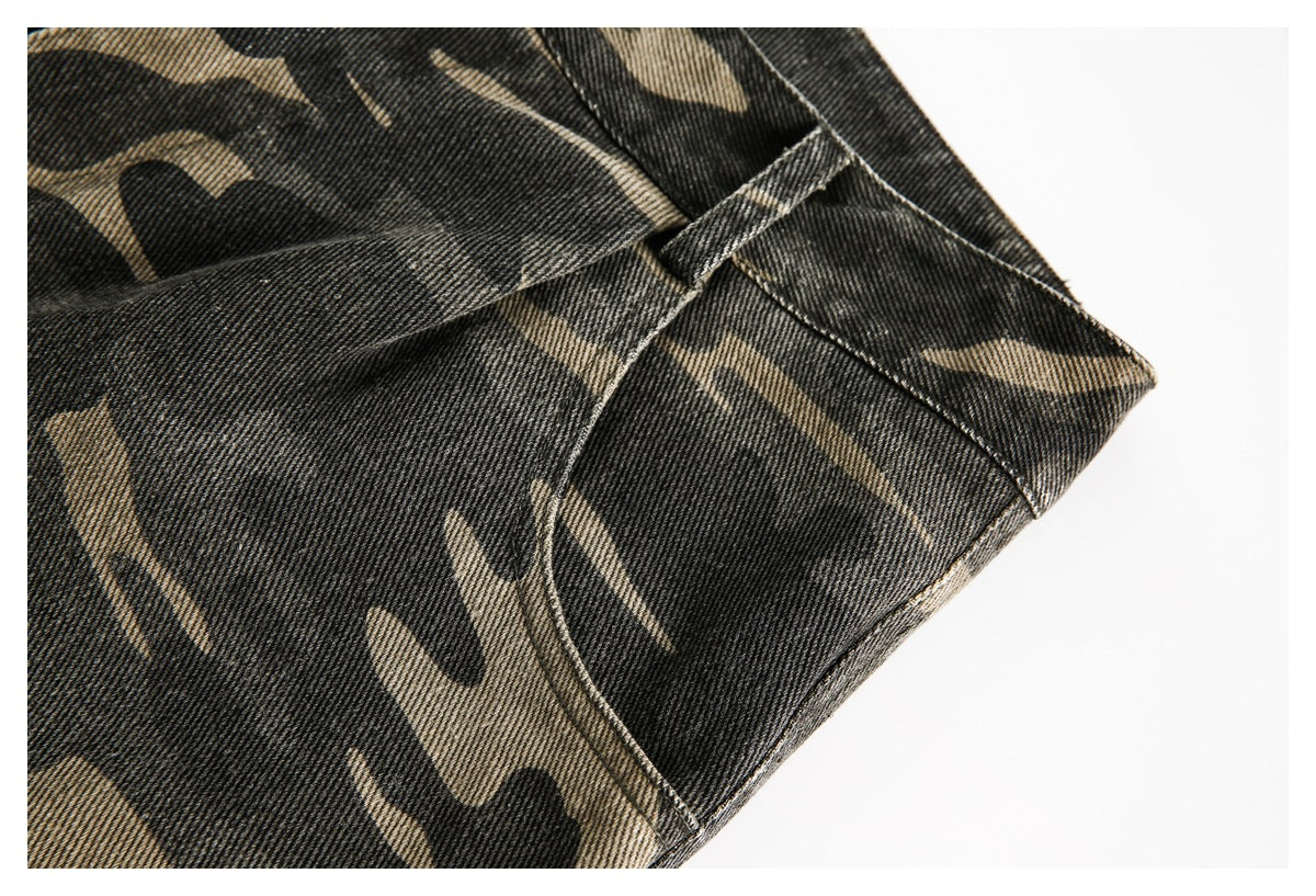 Close-up of charcoal and khaki camouflage trousers showing a belt loop and stitched seams.