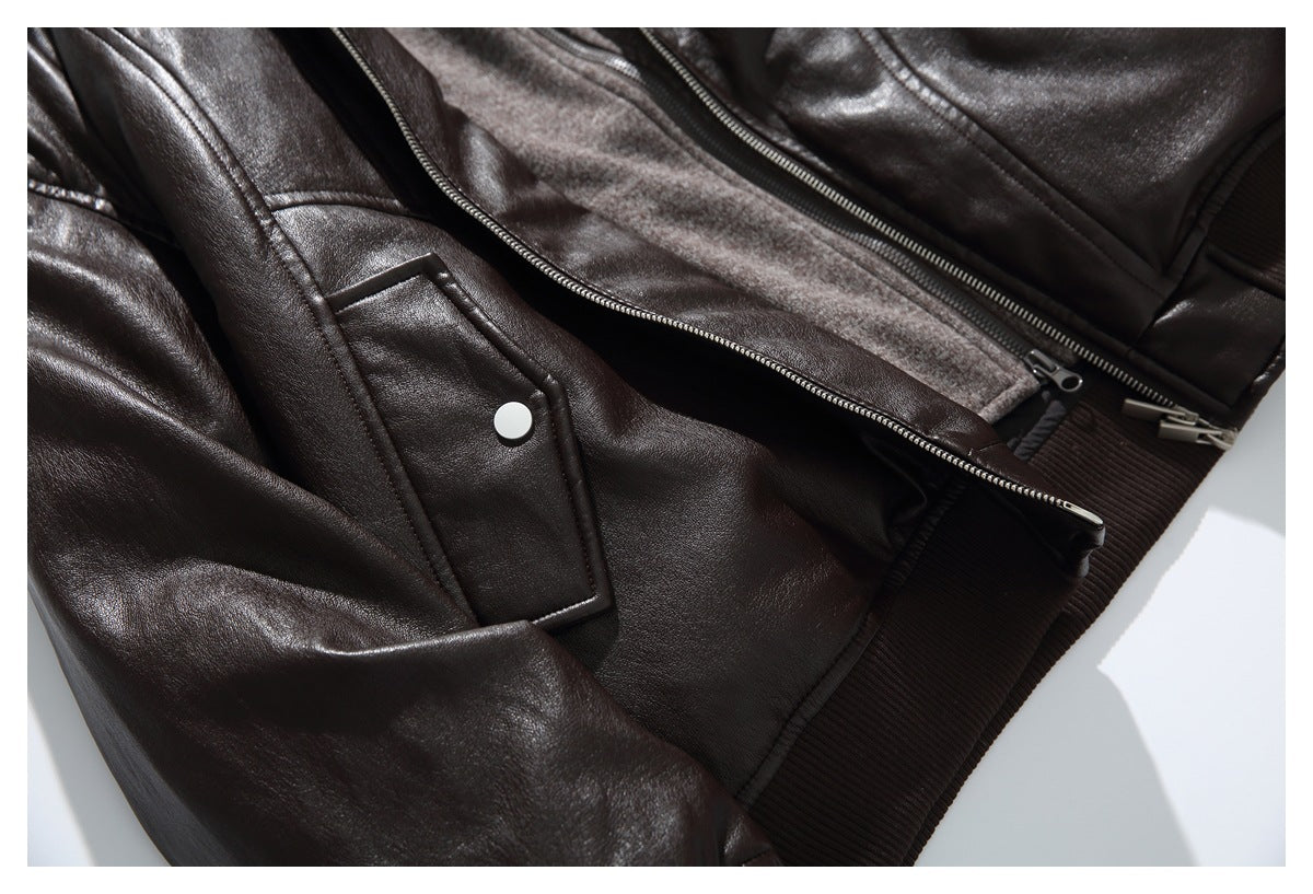 Close-up of a dark brown jacket showing its snap-flap pocket, front zipper, and ribbed hem.