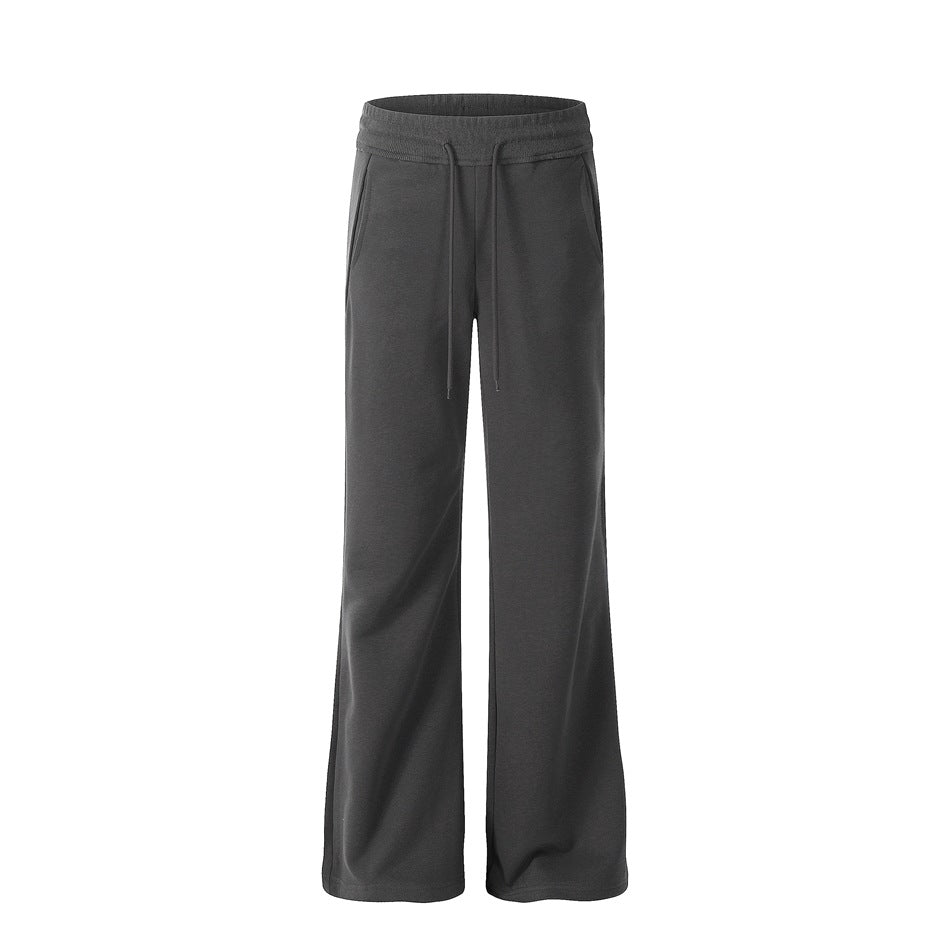 Dark gray flared drawstring pants with elastic waistband and side pockets, front view on white background