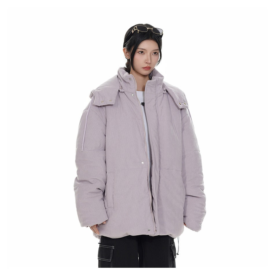 Model wearing an open light purple ribbed puffer jacket with the hood resting on the shoulders, over a white top