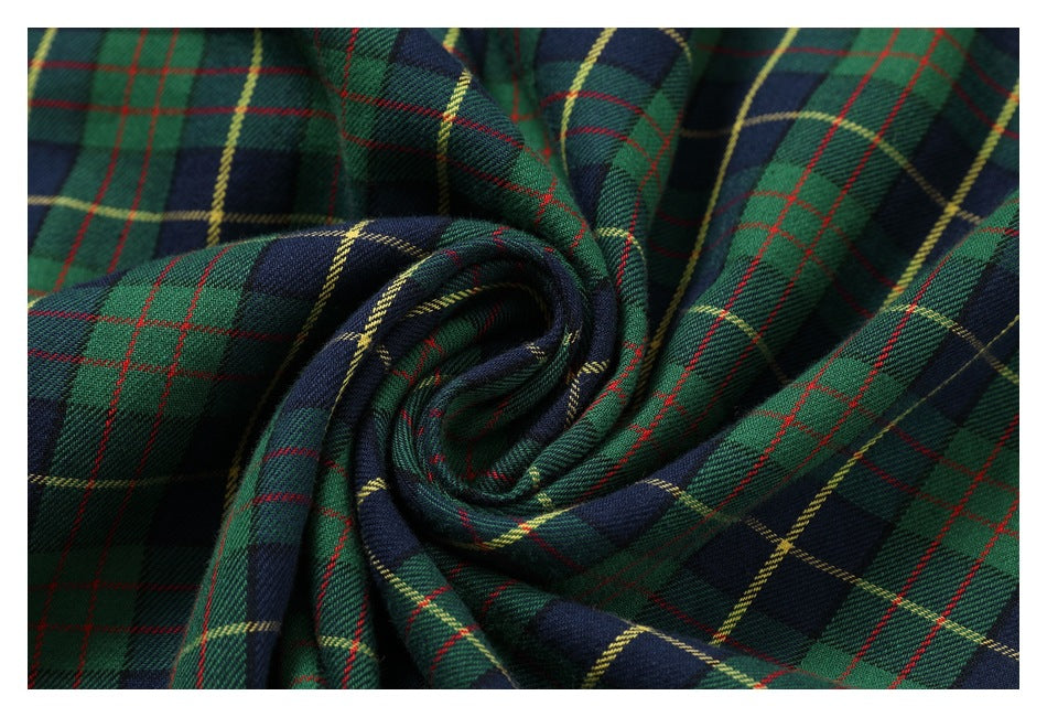 Close-up of green, navy, red, and yellow plaid fabric gathered into a spiral fold.