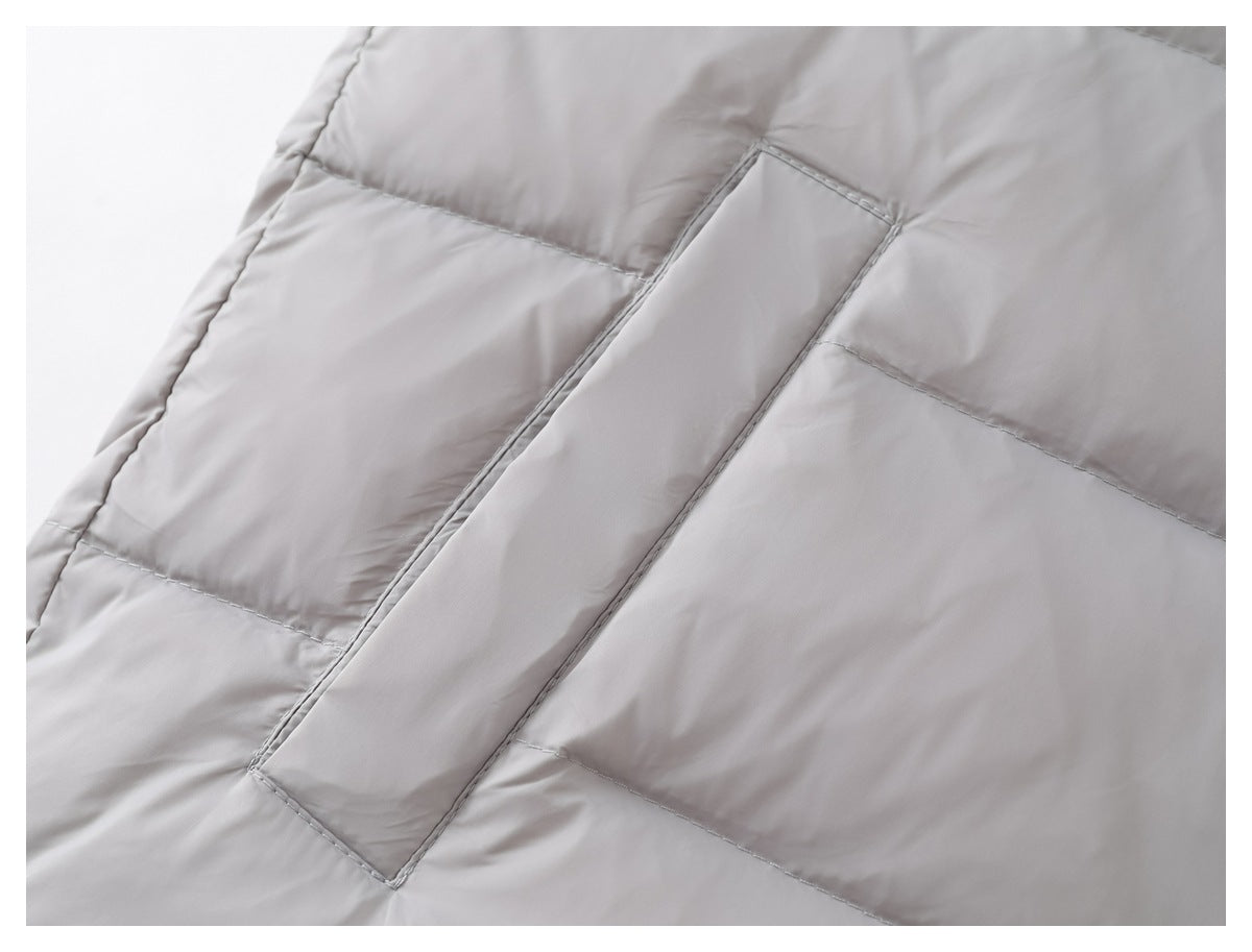 Close-up of a narrow stitched flap and horizontal quilting on the light gray vest.