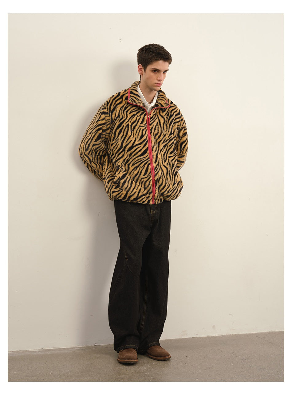 Full-length model in a tan-and-black tiger-stripe fleece jacket with red front zipper and loose black jeans.