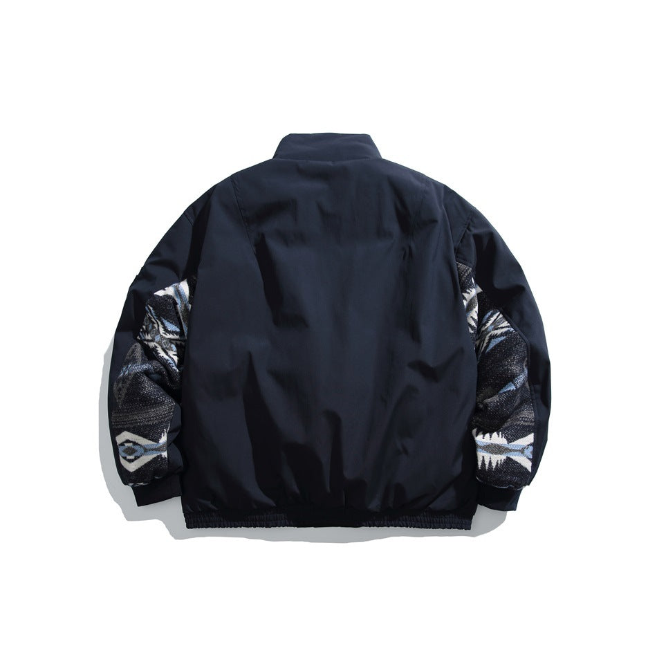 Back view of a dark navy jacket with contrasting black, white and blue patterned sleeve panels and a gathered hem.