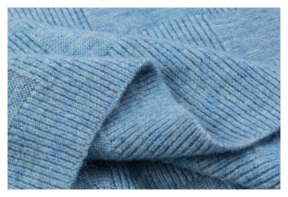 Close-up showing the light blue cardigan's ribbed knit trim and folded edge.