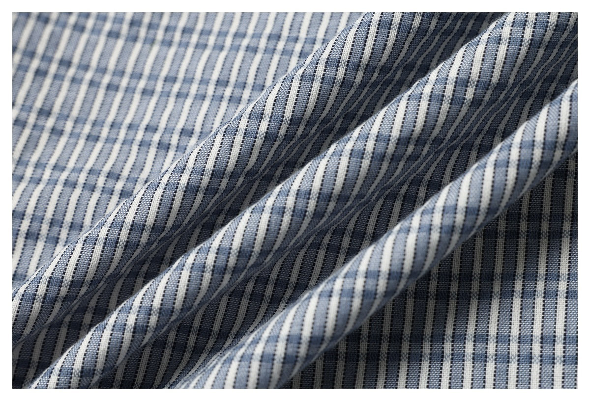 Close-up showing the drape and blue-and-white stripe pattern of the garment fabric.