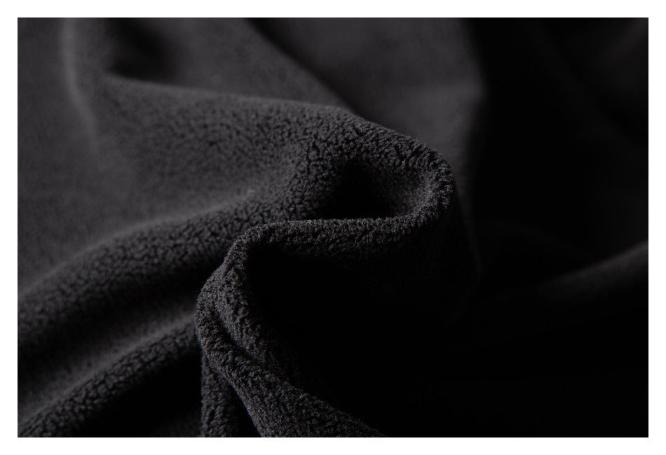 Close-up of black fabric with a dense, fuzzy textured surface.