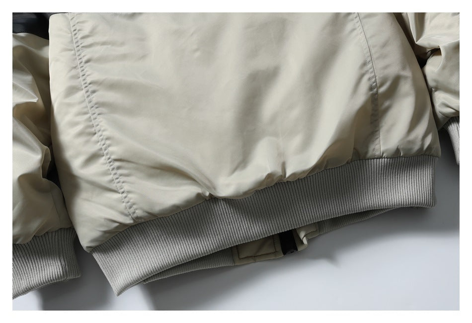 Close-up of the light beige jacket hem with a wide gray ribbed band.