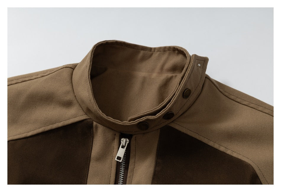 Close-up of the jacket's tan stand collar with snap buttons and a metal front zipper.