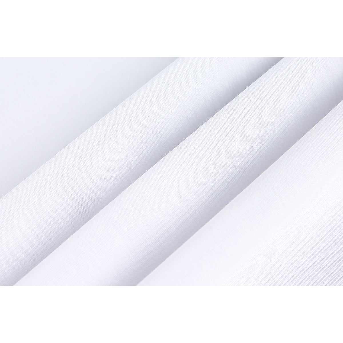 Close-up of white fabric draped in folds, showing its fine surface texture.