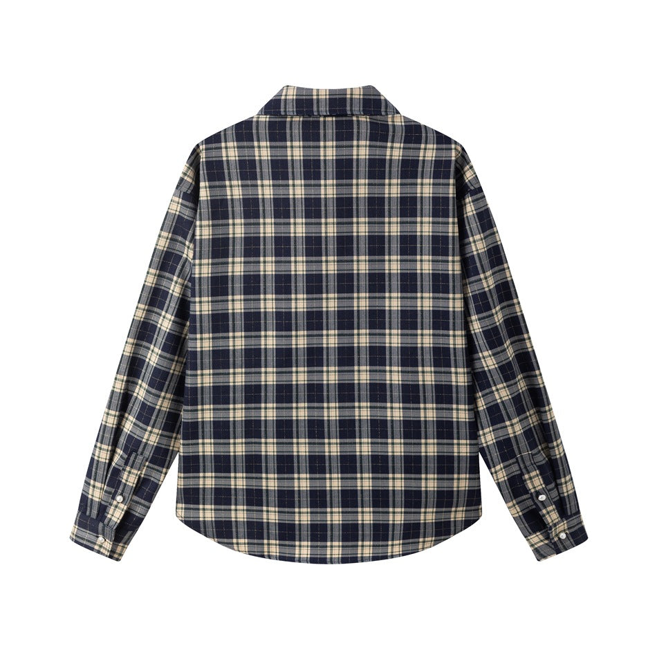 Back view of a navy and cream plaid long-sleeve shirt laid flat, showing its rounded hem and buttoned cuffs.
