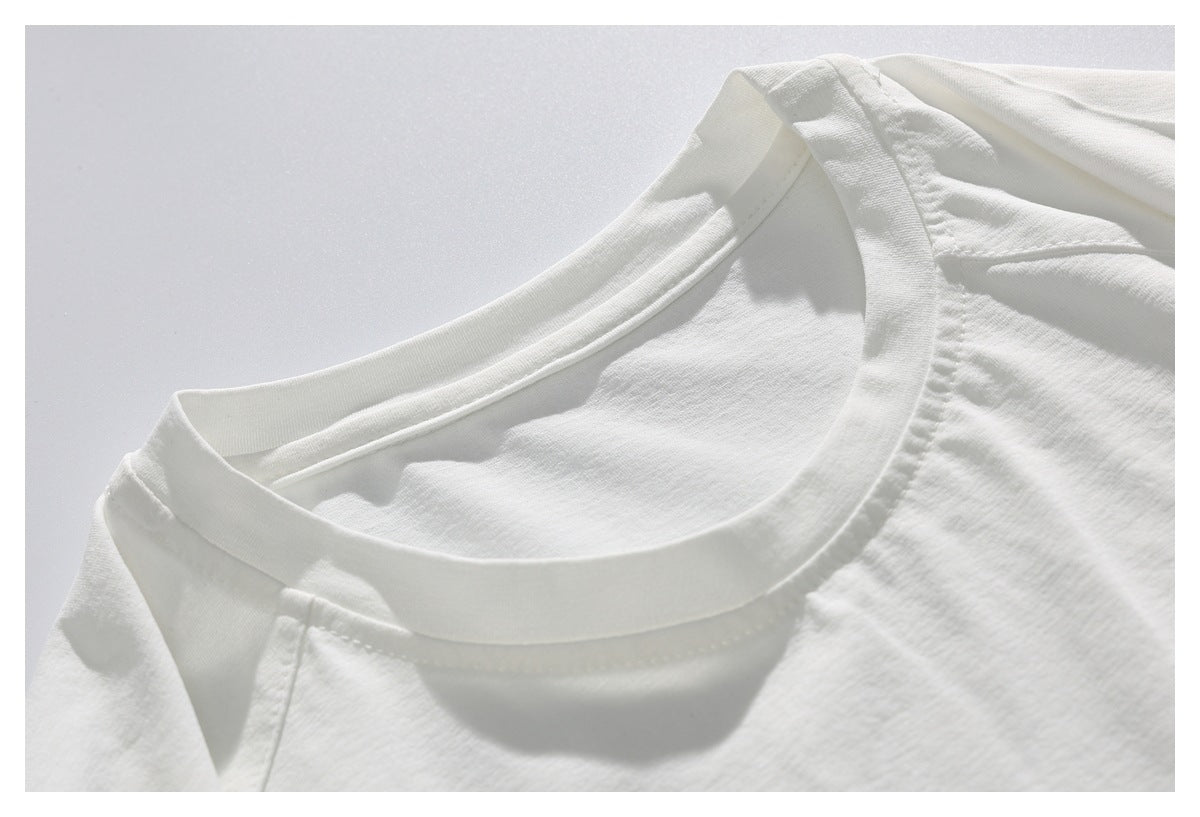 Close-up of the crew neckline and shoulder seams on a plain white T-shirt.