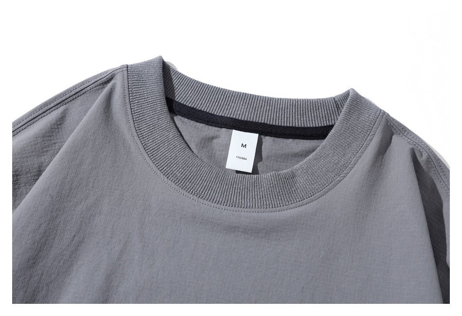 Close-up of the gray shirt's ribbed crewneck collar and inner size tag marked M and 170/88A.