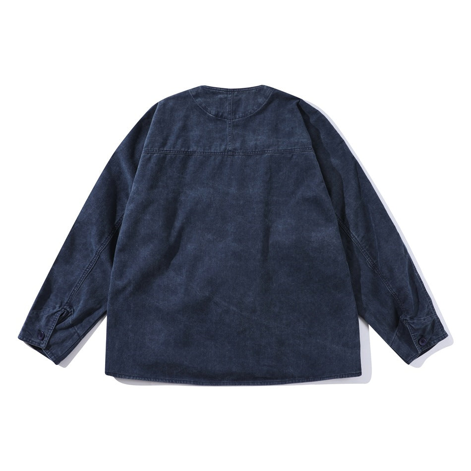 Back view of a dark indigo jacket with long sleeves, a curved neckline, and a horizontal upper-back seam.