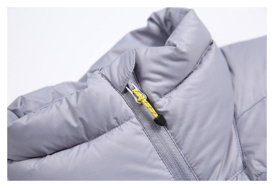 Close-up of the light gray vest's padded collar and zipper with a yellow cord pull.