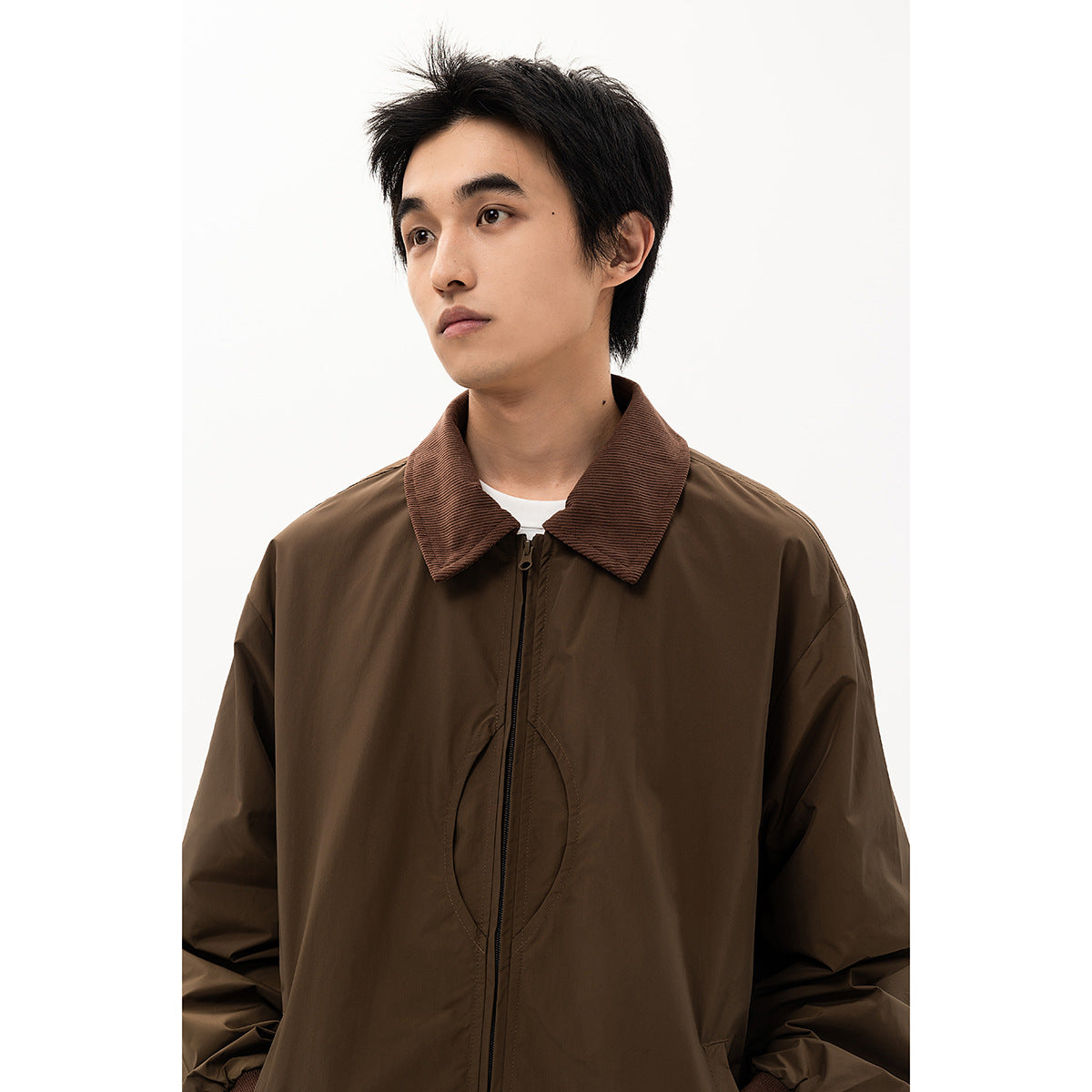Model wearing a dark brown zip-front jacket with a wide brown striped collar.