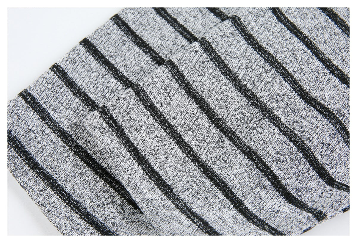 Close-up of gray knit fabric with narrow black stripes, shown in soft folds.