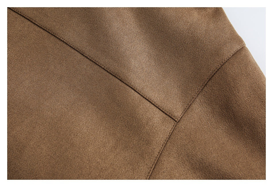 Close-up of brown jacket fabric with intersecting stitched seams.