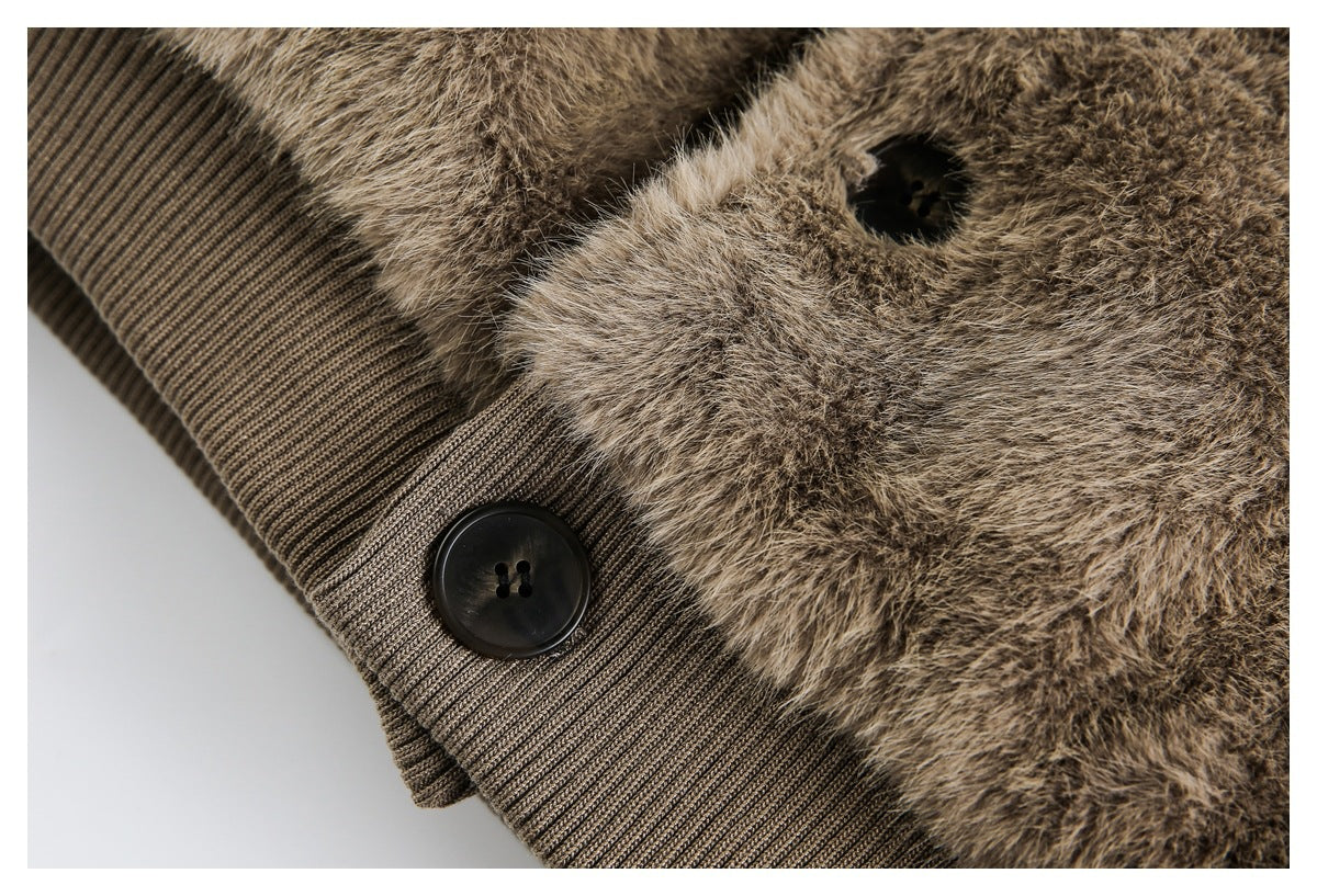 Close-up of brown faux-fur trim beside a ribbed knit band with a large black button.
