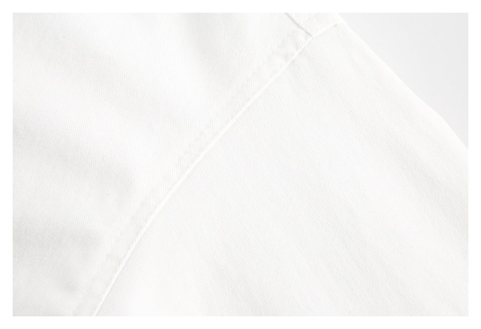 Close-up of a diagonal stitched seam on white garment fabric.