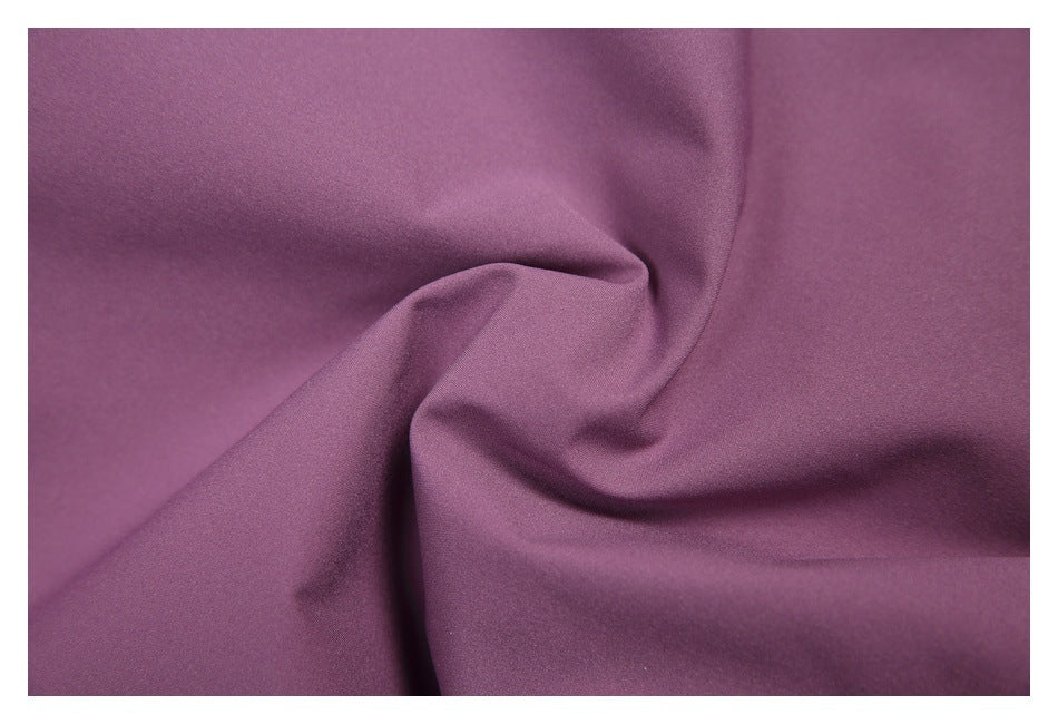 Close-up of plain purple fabric with soft folds.