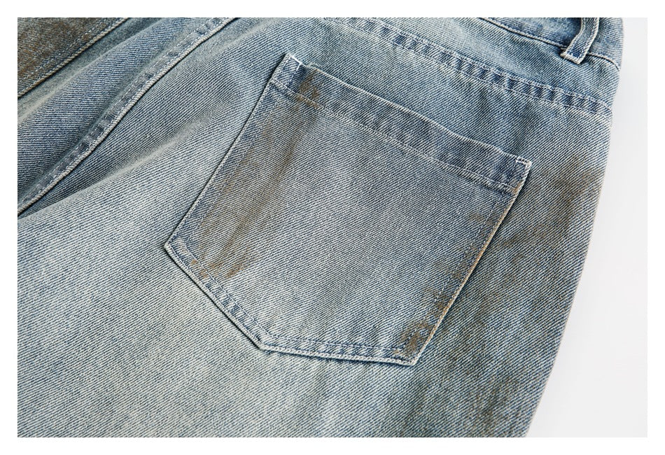 Close-up of a rear patch pocket on light blue faded jeans.