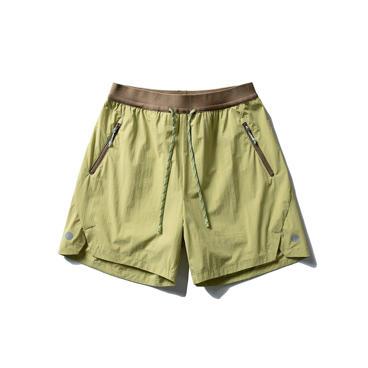 Lime green drawstring shorts with brown waistband, zippered front pockets and green rope cord, flat lay