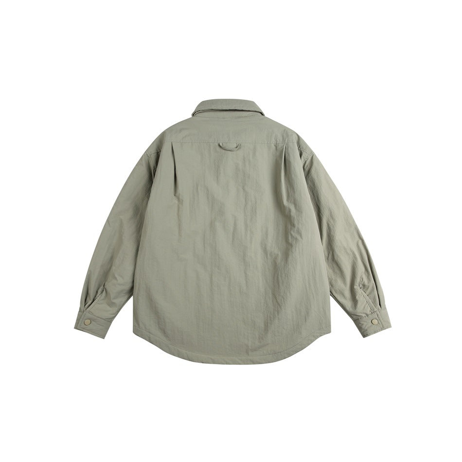 Back view of a light gray-green jacket with long sleeves, button cuffs and a curved hem.