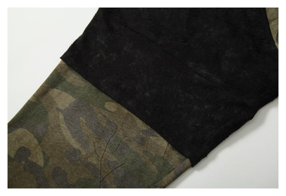 Close-up showing the black shoulder panel joined to the olive camouflage sleeve.