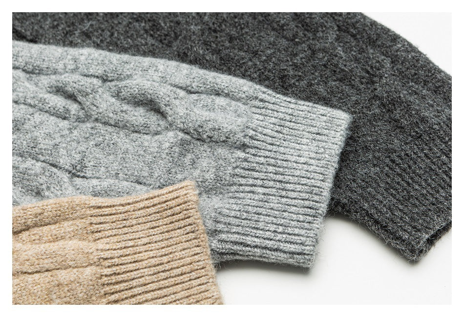 Close-up of cable-knit cardigan cuffs in beige, light gray, and charcoal.