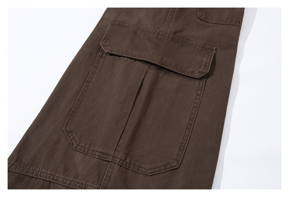 Close-up of dark brown trousers showing a large flap cargo pocket with stitched edges.