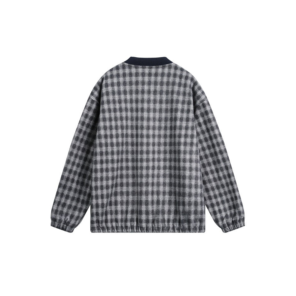Back view of a gray plaid jacket with a navy ribbed collar, long sleeves, and gathered cuffs and hem.