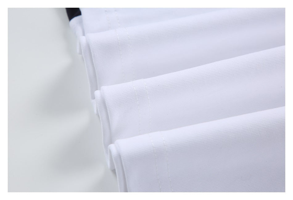 Close-up of white garment fabric with parallel stitched seams along folded edges.