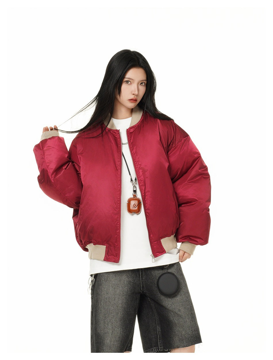 Model wearing an open red oversized jacket with beige ribbed trim, shown from the front.