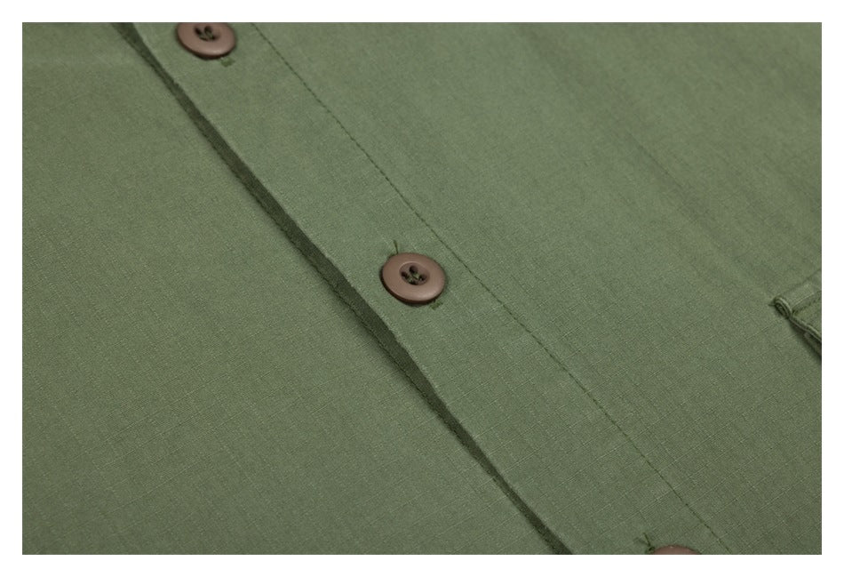 Close-up of the olive-green jacket's front placket, brown buttons and fabric texture.