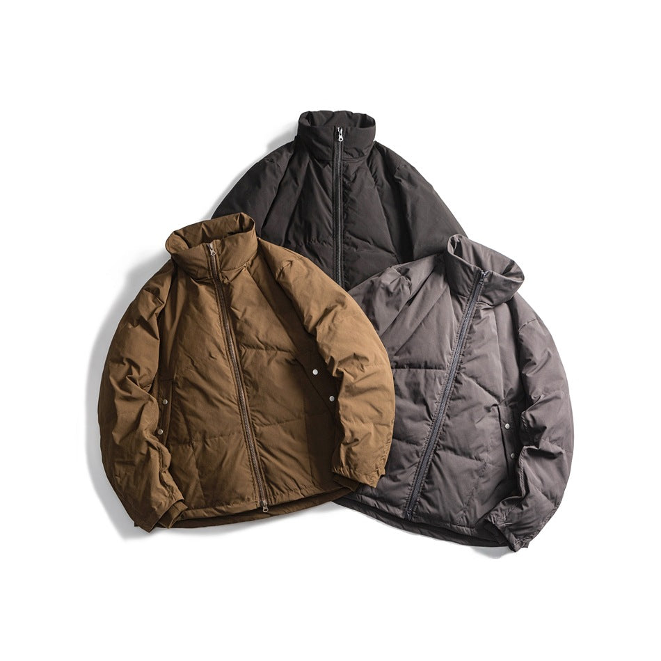 Three puffer jackets arranged together in black, brown, and charcoal gray, shown from the front.