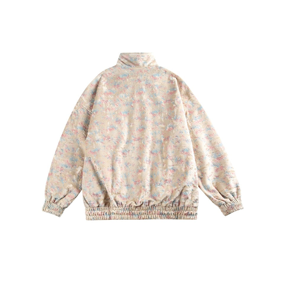Back view of a pastel multicolor zip-up jacket with a high collar and elastic cuffs and hem.