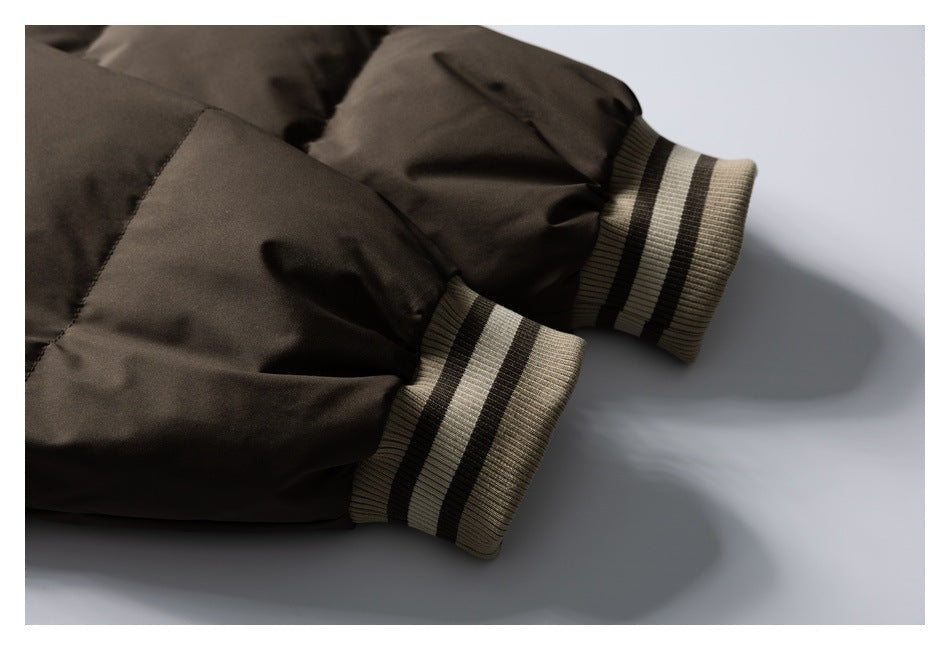 Close-up of a dark brown jacket sleeve with beige-and-dark striped ribbed cuffs.