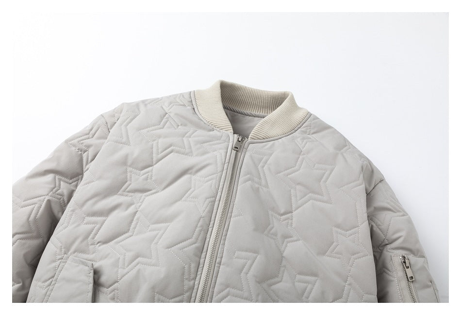 Close-up of a light gray star-quilted bomber jacket showing the front zipper, cream ribbed collar, and sleeve pocket zipper.