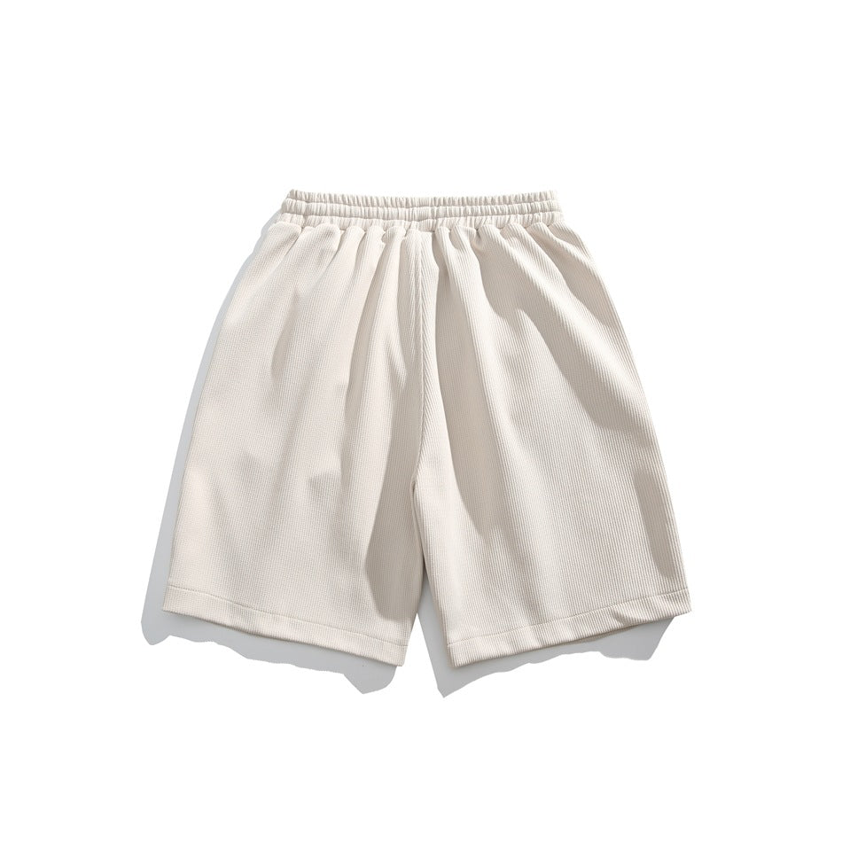 Ivory shorts shown flat from the front, with an elastic waistband and straight hems.