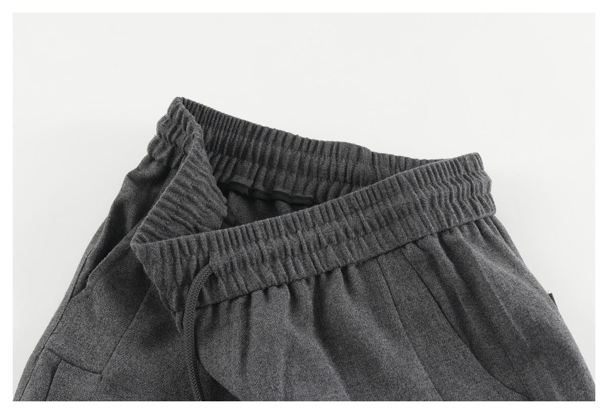 Close-up of the charcoal pants' elastic waistband folded open to reveal the inside and drawstring.