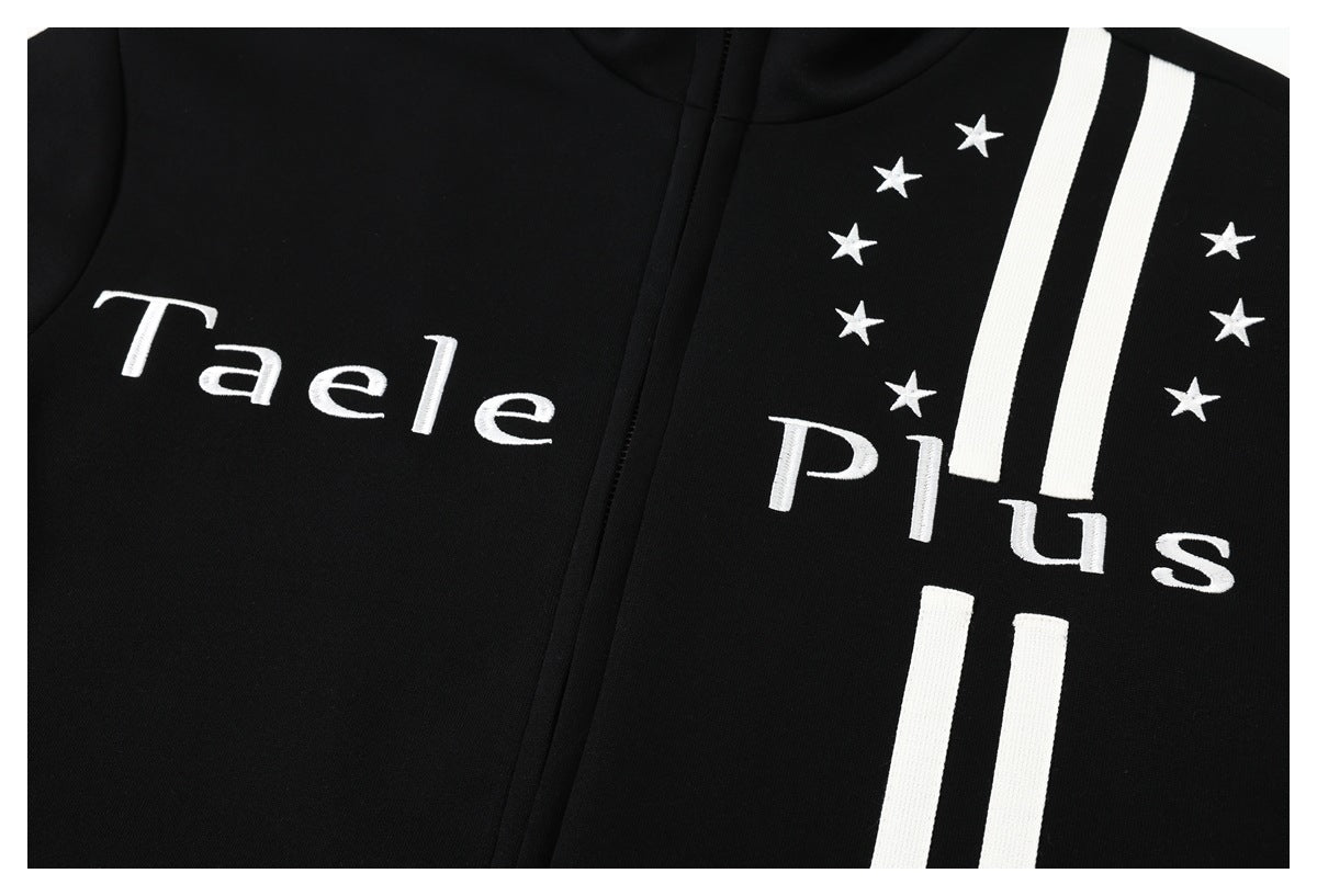 Close-up of a black garment with white embroidered lettering, stars, and vertical stripes.
