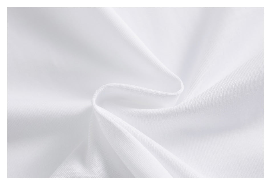 Close-up of smooth white fabric draped into soft folds.