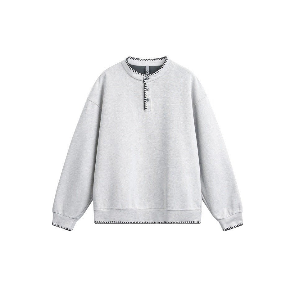 Light gray Henley-style sweatshirt with black whipstitch trim on collar, placket, cuffs and hem, flat lay