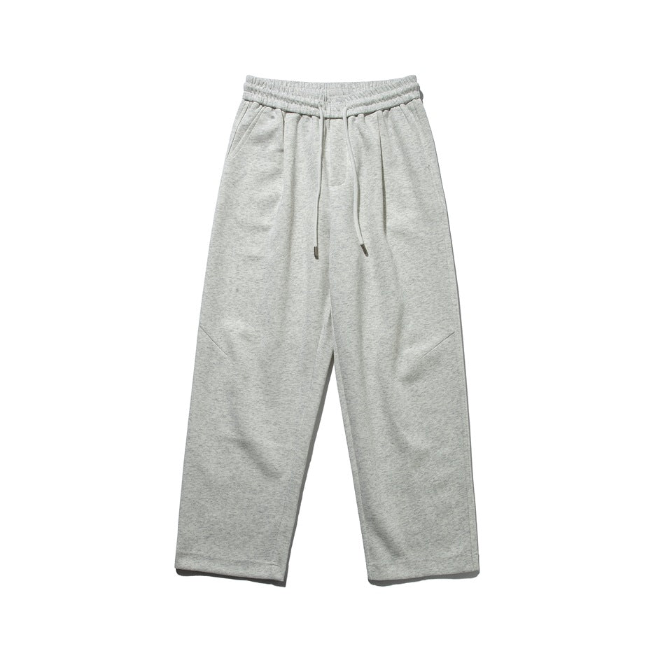 Heather gray drawstring sweatpants with elastic waist and diagonal knee seams, flat lay front view